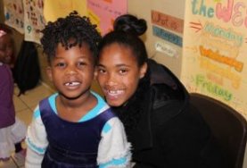 A local teacher with a young child at a South African kindergarten in Cape Town, Africa.