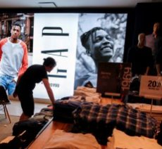 A worker arranges clothes at the GAP clothing retail store in Manhattan, New York