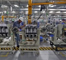 An employee assembles medium voltage switchgears inside the plant of Schneider Electric Infrastructure Ltd. on the outskirts of Vadodara in Gujarat