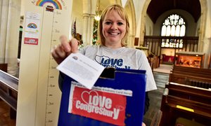 Becci North with the box where villagers are noting their random acts of kindness.