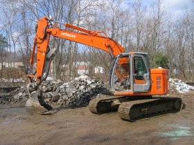 Image of an excavator at a construction site.