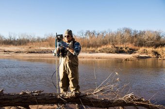 Oklahoma Water Resources Board project coordinator Jason Murphy takes water samples at the Canadian River east of Oklahoma City.