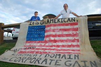 Roy Christman (left) and William Kellner outside a FERC meeting on the proposed PennEast pipeline where they displayed a banner objecting to the possible use of eminent domain by pipeline companies to enable construction on private land.