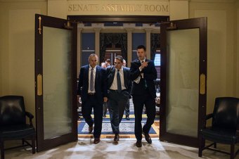 State Senators Greg Treat, Clark Jolley and David Holt emerge from a Republican Caucus meeting after members agreed on a framework for a .8 million state budget.